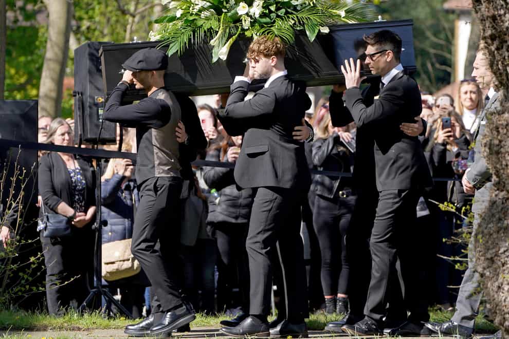 Max George (left) and Jay McGuiness of The Wanted (centre) carry the coffin at the funeral of their bandmate Tom Parker (Kirsty O’Connor/PA)