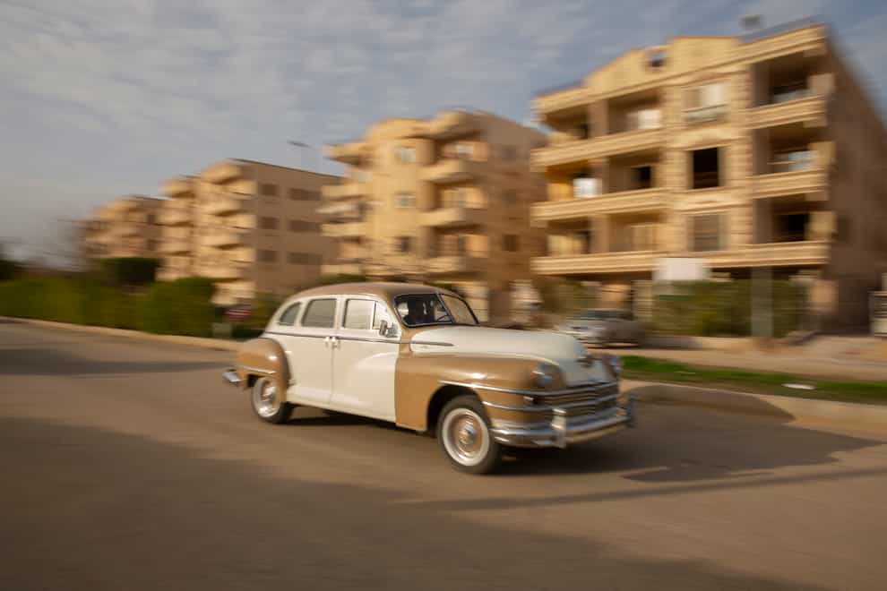 Egyptian collector Mohamed Wahdan drives ha 1948 Chrysler in Obour city, near Cairo, Egypt (Amr Nabil/AP)