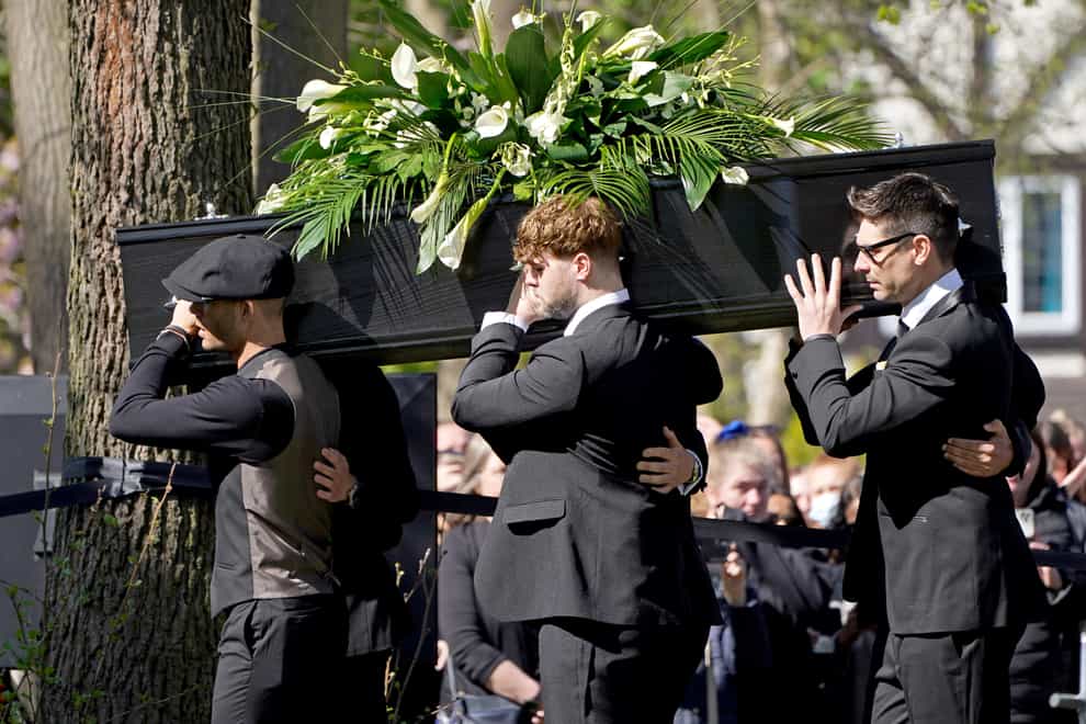 Max George (left) and Jay McGuiness (centre) of The Wanted carry the coffin at the funeral of their bandmate Tom Parker (Kirsty O’Connor/PA)