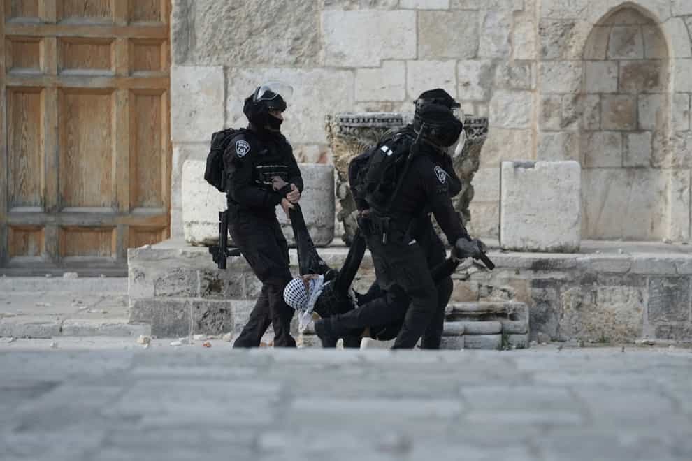 Israeli police carry a Palestinian protester during clashes at the Al Aqsa Mosque compound in Jerusalem’s Old City (AP)
