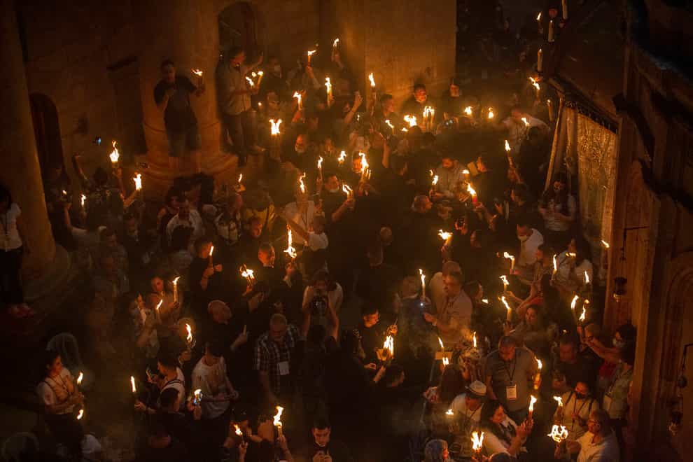 Christian pilgrims hold candles as they gather during the ceremony of the Holy Fire at Church of the Holy Sepulchre (Ariel Schalit/AP)