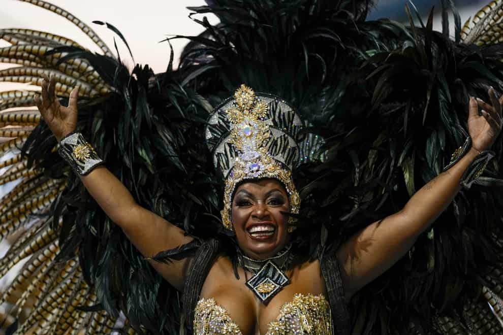 A dancer from the Academicos do Tatuape samba school performs during a carnival parade in Sao Paulo, Brazil, on Saturday April 23 2022 (Andre Penner/AP)