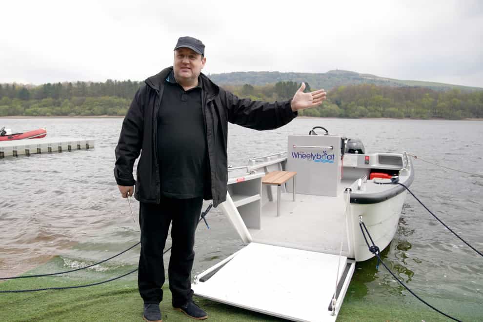 Comedian Peter Kay launches the Coulam Wheelyboat V17 at the Anderton Centre located on the banks of the Lower Rivington Reservoir near Bolton in Lancashire (Peter Byrne/PA)
