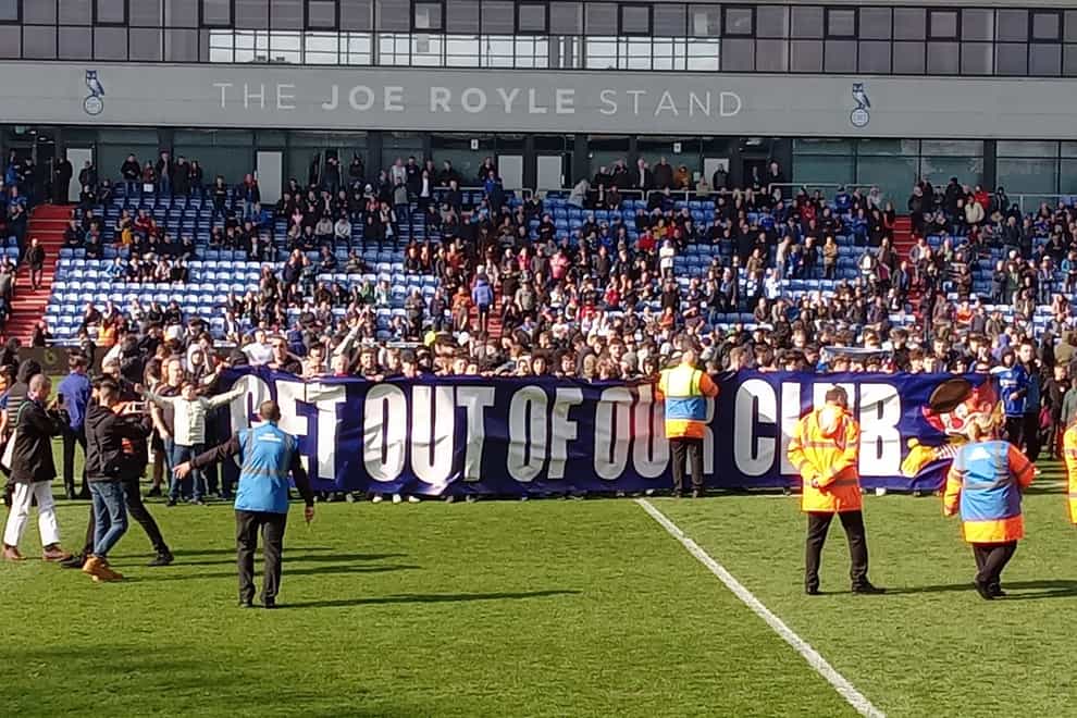 Oldham fans invaded the pitch to protest during the match against Salford (Lee Morris/PA).