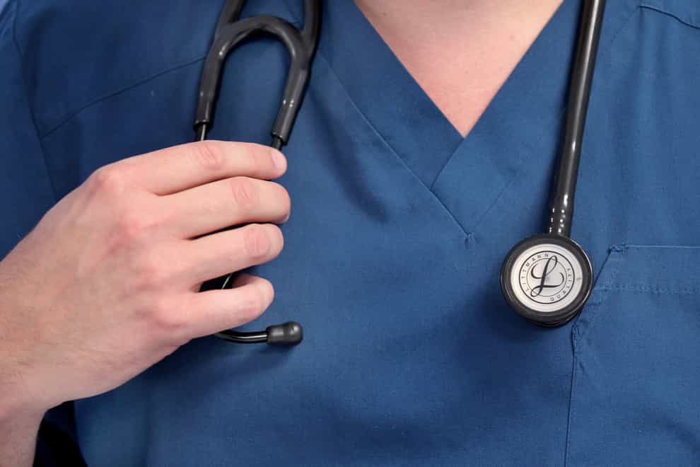 A Doctor holds a stethoscope at the Royal Liverpool University Hospital, Liverpool (PA)