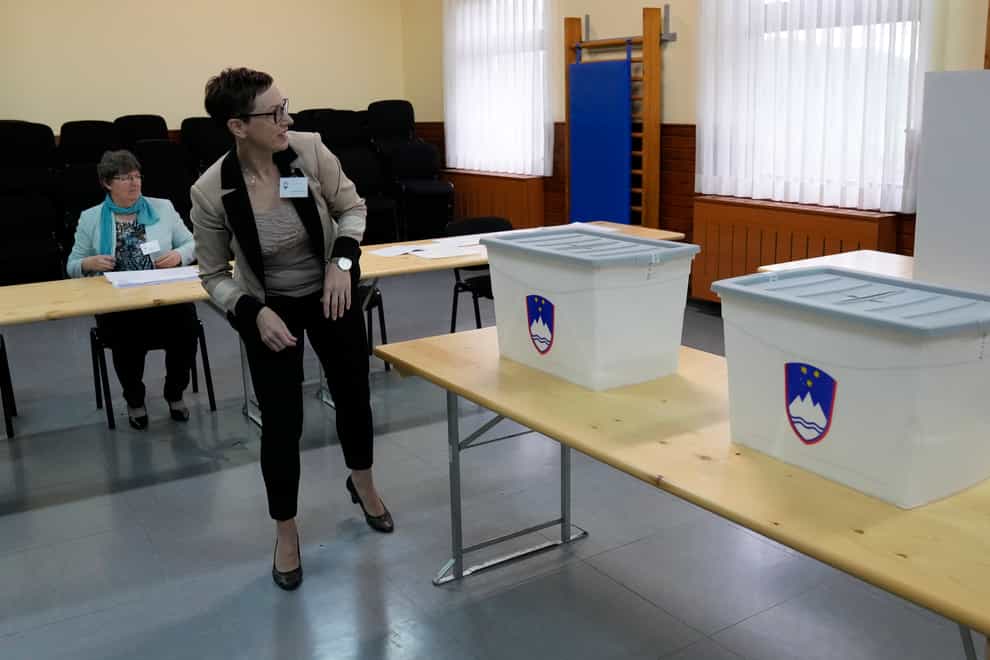 A member of electoral commission inspects ballot boxes at a polling station in Sentilj (AP Photo/Darko Bandic)