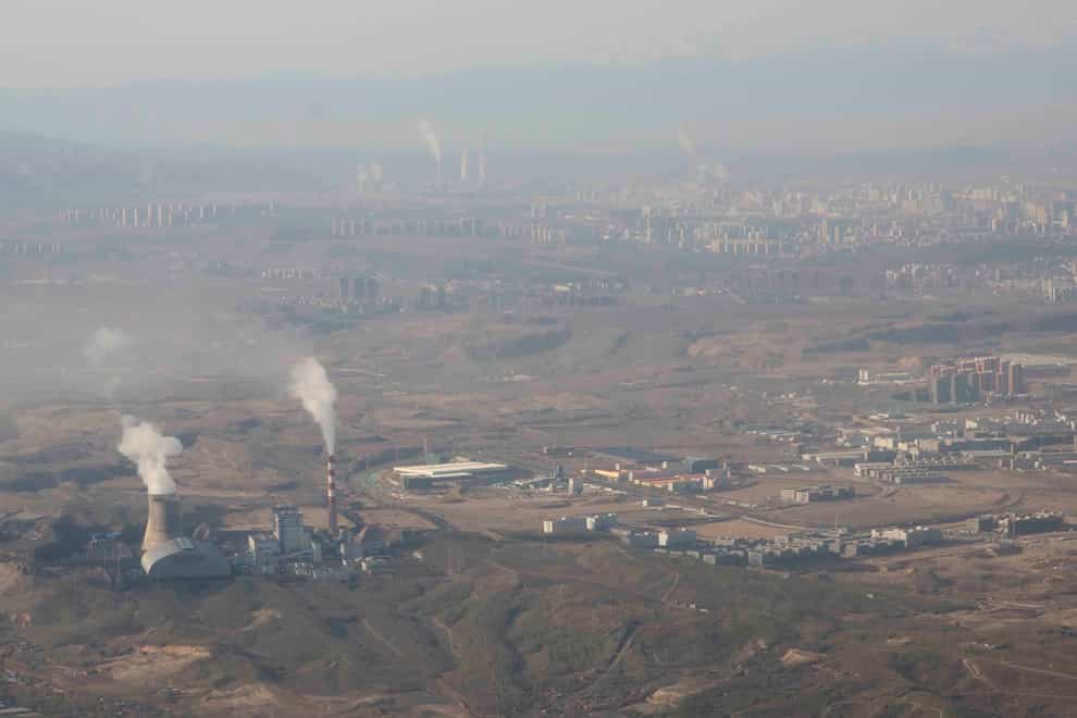 Smoke and steam rise from towers at the coal-fired Urumqi Thermal Power Plant in western China’s Xinjiang Uyghur Autonomous Region (Mark Schiefelbein/AP)