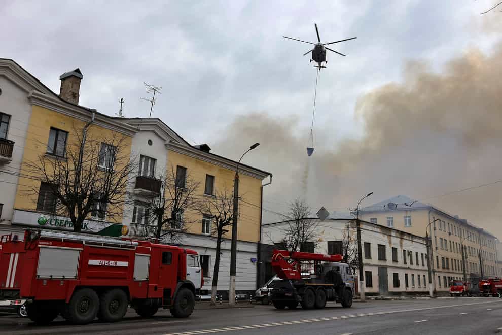 A helicopter drops water in a bid to tackle a fire in the Russian city of Tver (Vitaliy Smolnikov/Kommersant Publishing House via AP)