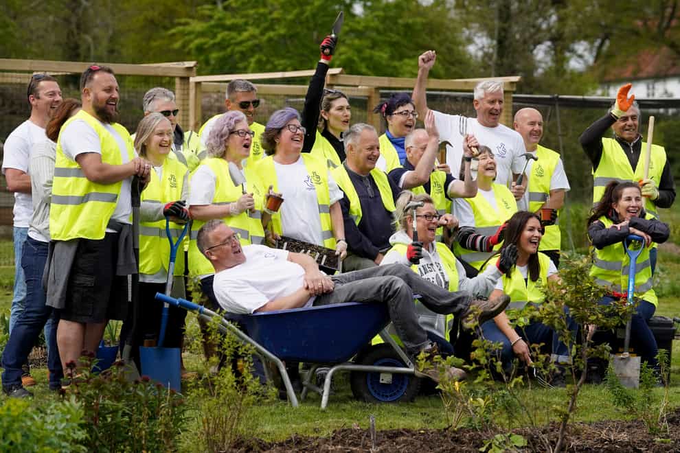Twenty-one National Lottery winners, with a combined wealth of £146 million, help to lay paths and fences at Rocks Farm Oast, in Hastings, Sussex, after volunteering to help the Veterans’ Growth charity. Picture date: Thursday April 28, 2022 (Gareth Fuller/PA)