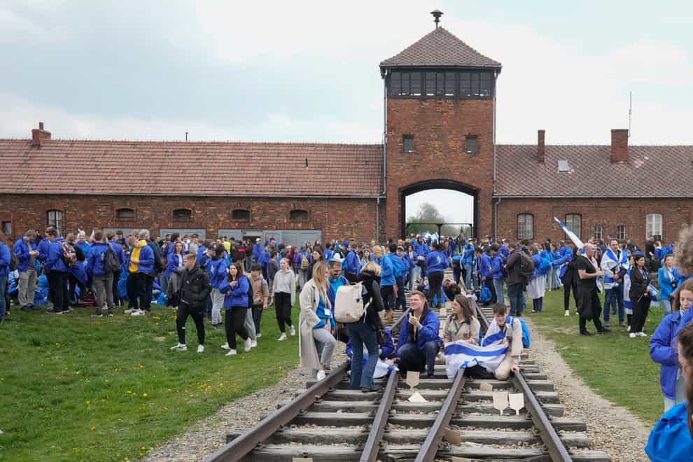 Jewish people visit the Auschwitz Nazi concentration camp after the March Of The Living annual observance that was not held for two years due to the global Covid-19 pandemic, in Oswiecim, Poland (Czarek Sokolowski/AP)