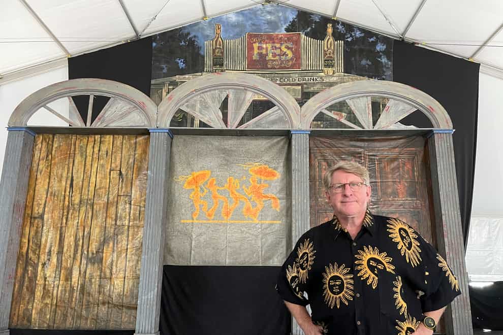 Quint Davis, producer of the New Orleans Jazz & Heritage Festival, stands on a stage of the festival’s Blues Tent (Kevin McGill/AP)