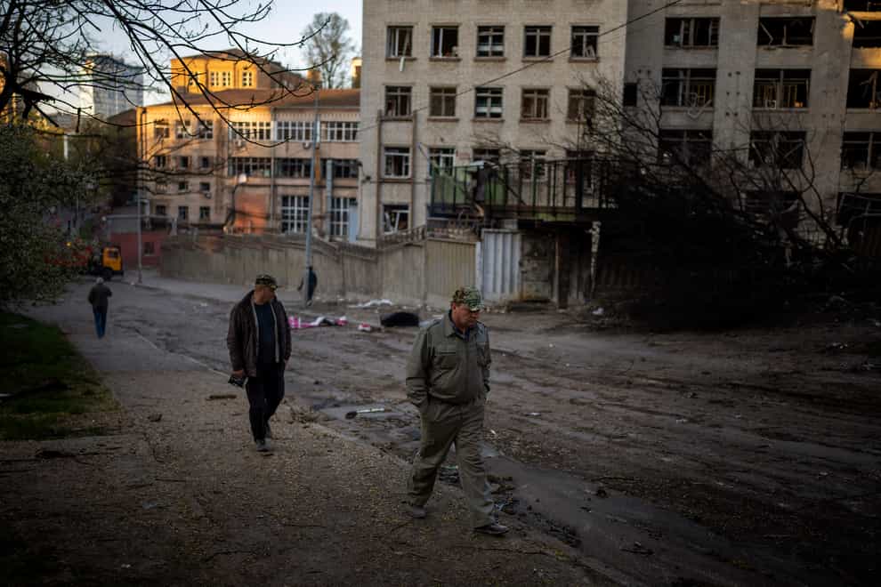 People walk past the site of an explosion in Kyiv, Ukraine (Emilio Morenatti/AP)