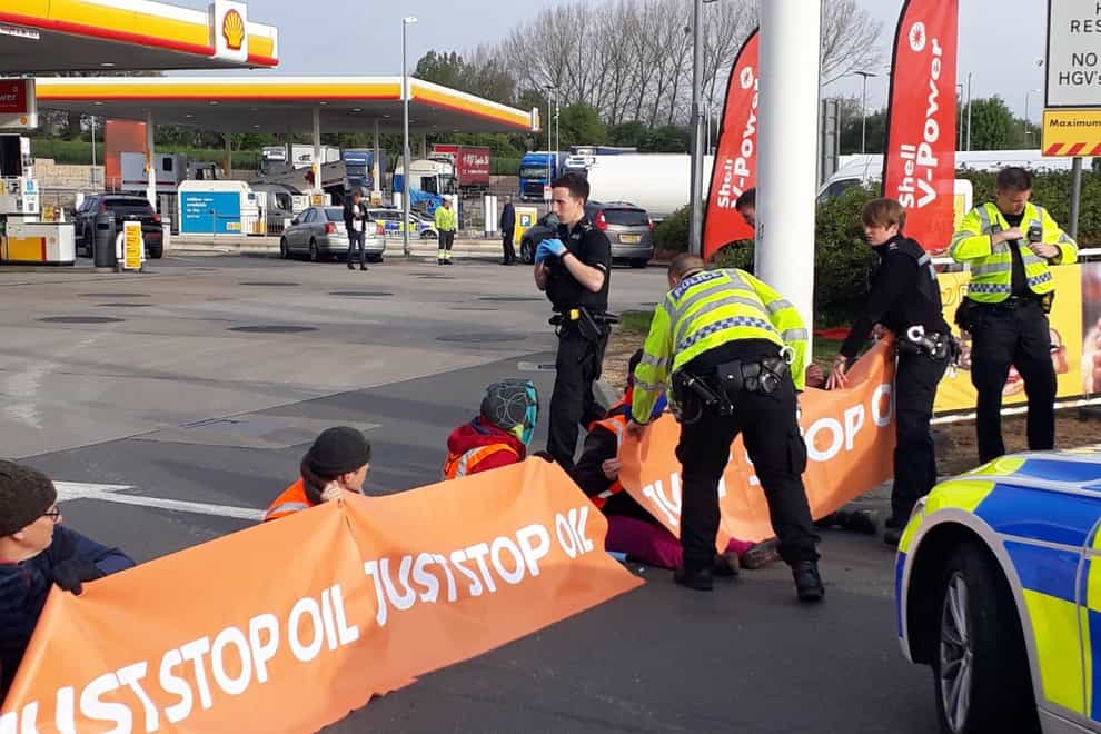 Just Stop Oil of campaigners stage a protest in the Shell petrol garage at the Cobham Services on the M25 in Cobham, Surrey (PA)