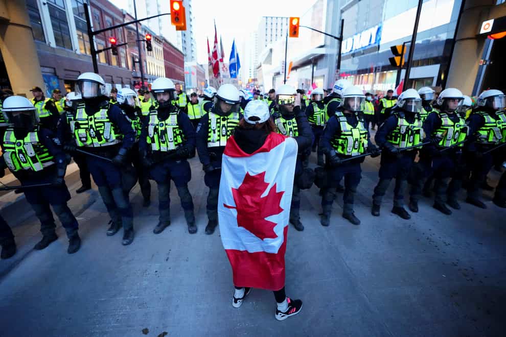 A protester confronts police during a demonstration in Ottawa (Sean Kilpatrick/The Canadian Press via AP)