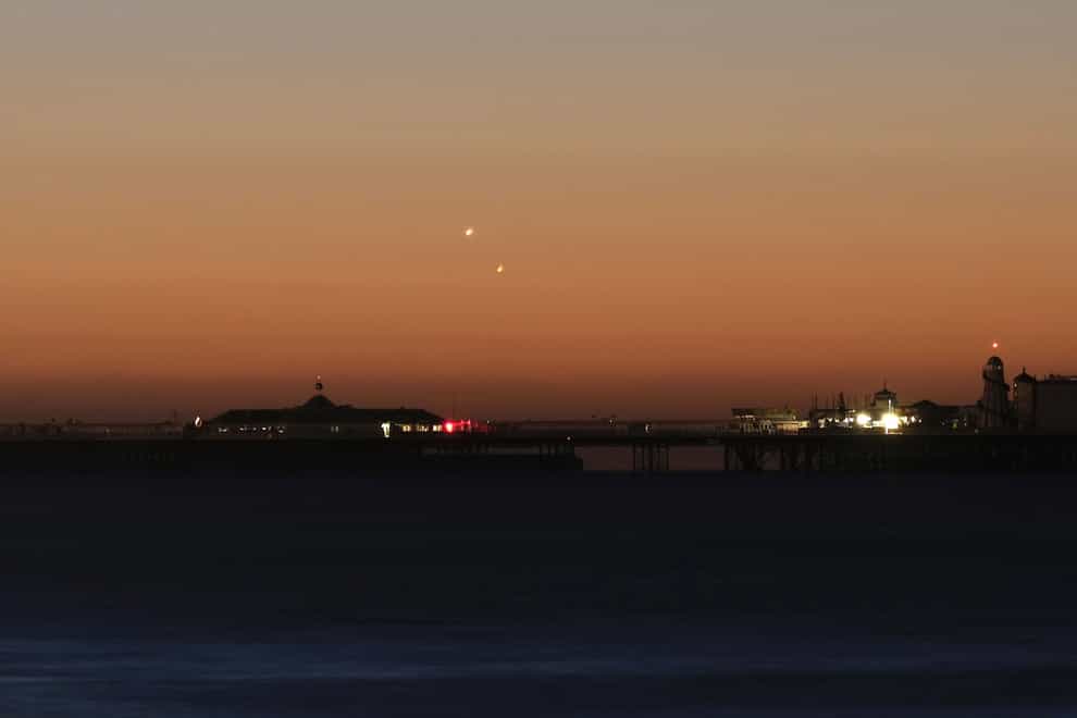 Handout photo of Venus (left) and Jupiter in the skies over Brighton Pier during a planetary conjunction (PA)