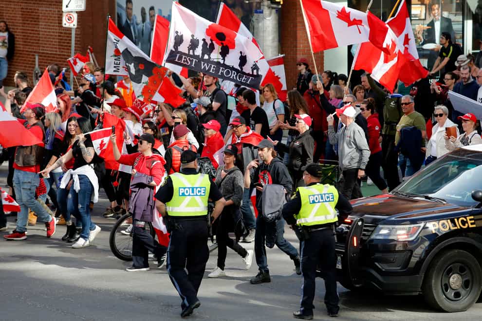 Motorcycles rumbled through the streets of Canada’s capital city on Saturday while a strong police presence kept a close eye on a couple of rallies during the ‘Rolling Thunder’ protest (Patrick Doyle/The Canadian Press via AP)