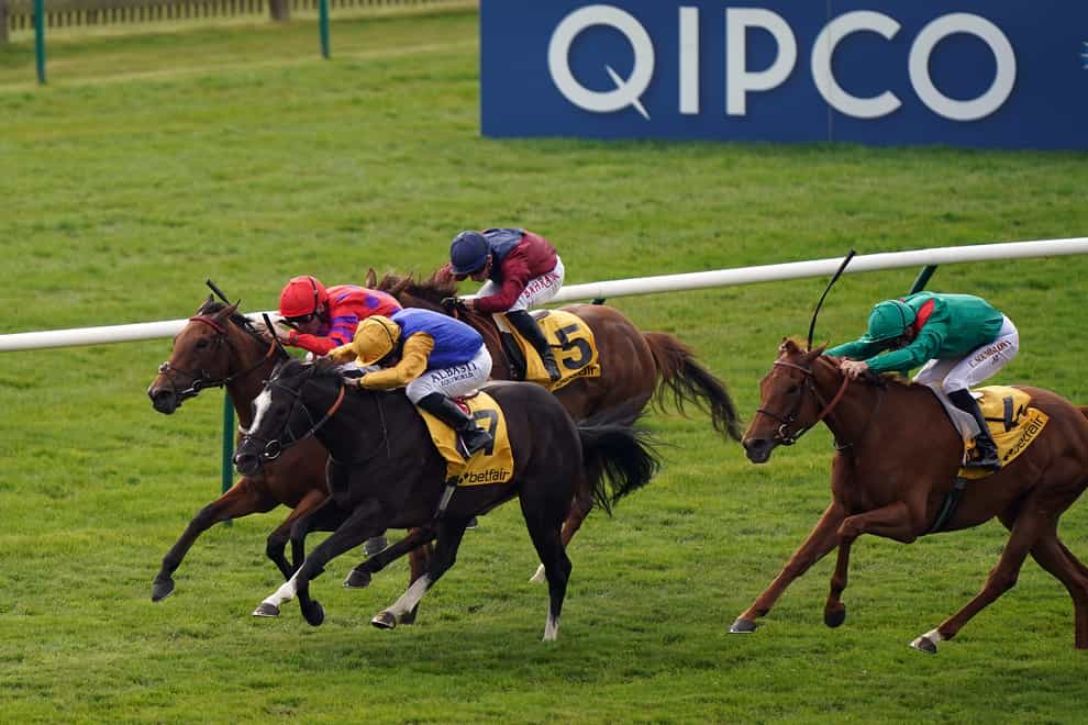 Dreamloper ridden by jockey Kieran Shoemark (red/purple) on their way to winning the Betfair Exchange Dahlia Stakes on day three of the QIPCO Guineas Festival at Newmarket Racecourse (Tim Goode/PA)