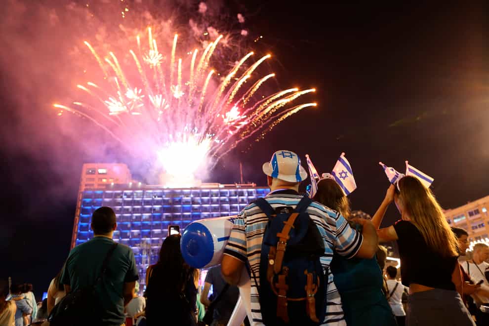 Israelis watch a fireworks display in Tel Aviv in 2018 (Oded Balilty/AP)