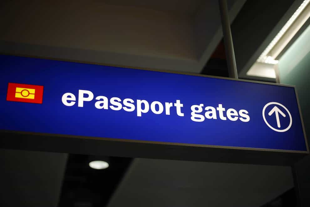 Signage for passport gates at an airport (Steve Parsons/PA)
