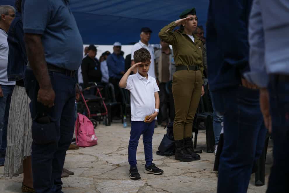 Israelis observe two minutes of silence as air raid sirens sound to mark Israel’s annual Memorial Day for fallen soldiers at the Armoured Corps memorial site, in Latrun, Israel, on Wednesday May 4 2022 (Ariel Schalit/AP)