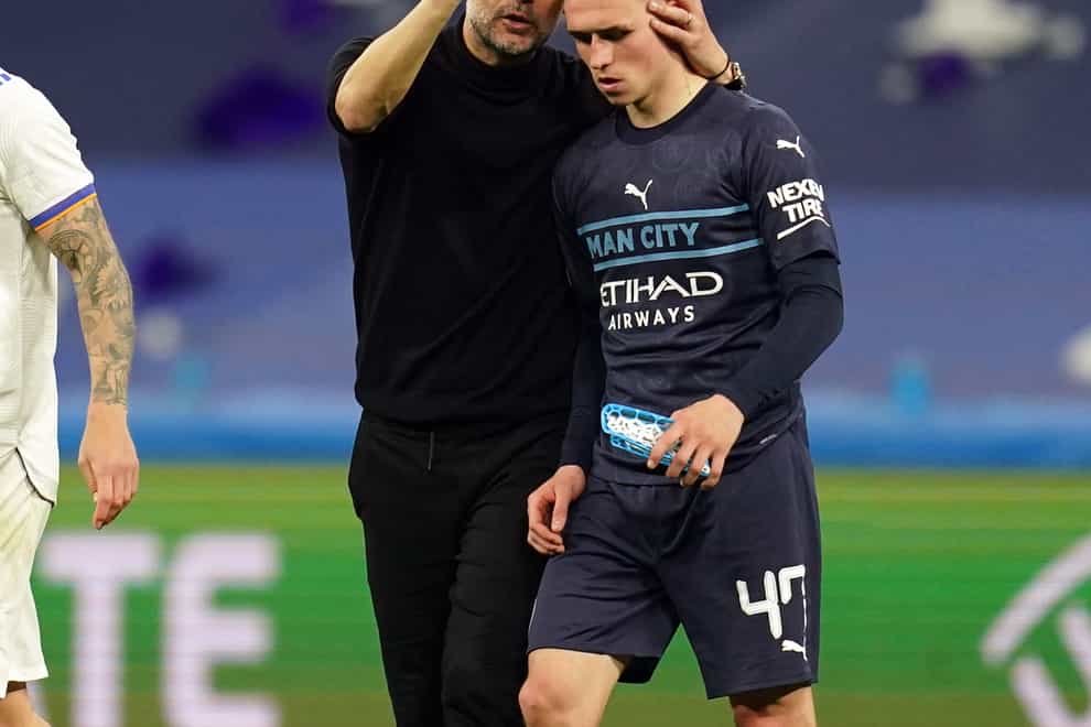 Pep Guardiola consoled Phil Foden after Manchester City’s agonising defeat (Nick Potts/PA)
