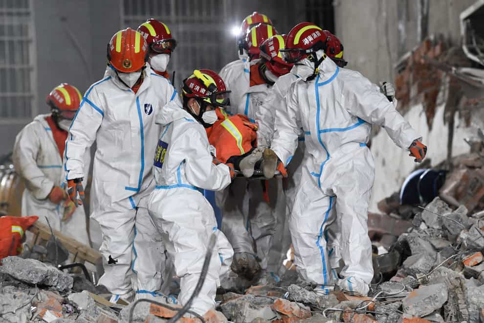 Rescuers in central China have pulled a woman alive from the rubble of a building that partially collapsed almost six days earlier, state media has reported.(Shen Hong/Xinhua via AP)