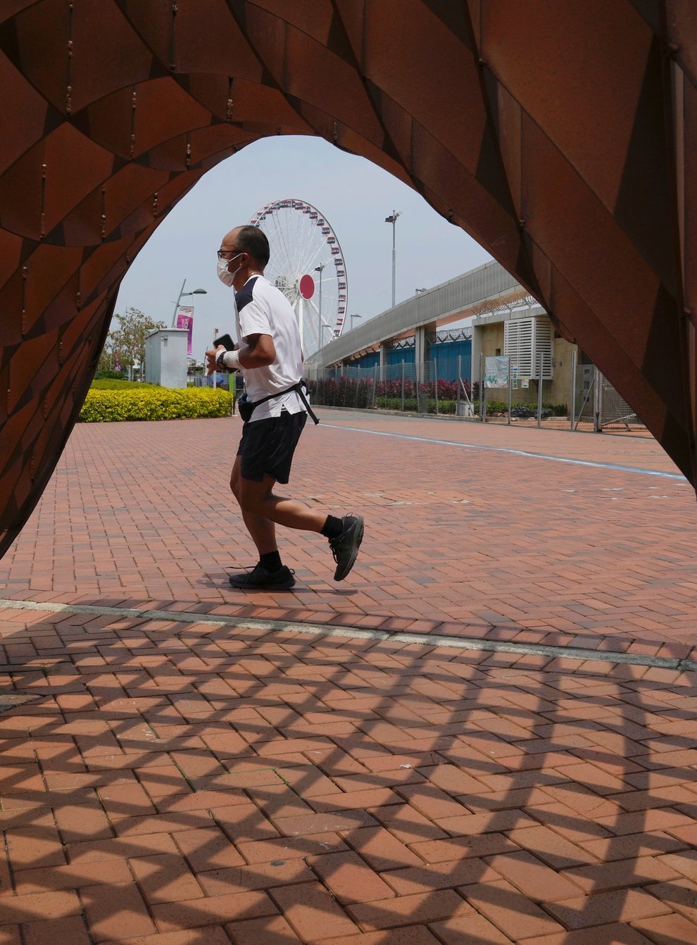 A man jogs in a park in Hong Kong on Thursday May 5 2022 (Kin Cheung/AP)