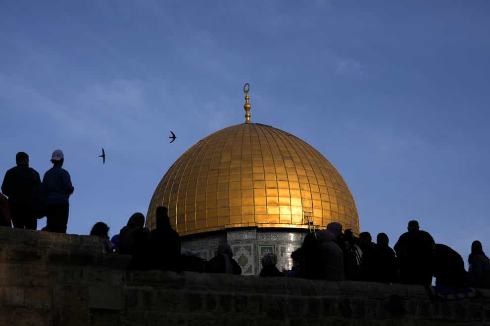 Muslims gather for prayers next to the Dome of the Rock Mosque in the Al-Aqsa Mosque compound (Mahmoud Illean/AP)