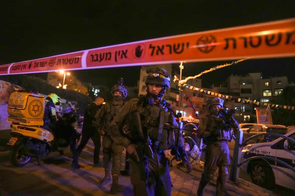 Israeli forces secure the area near a stabbing attack in the town of Elad (Maya Alleruzzo/AP)