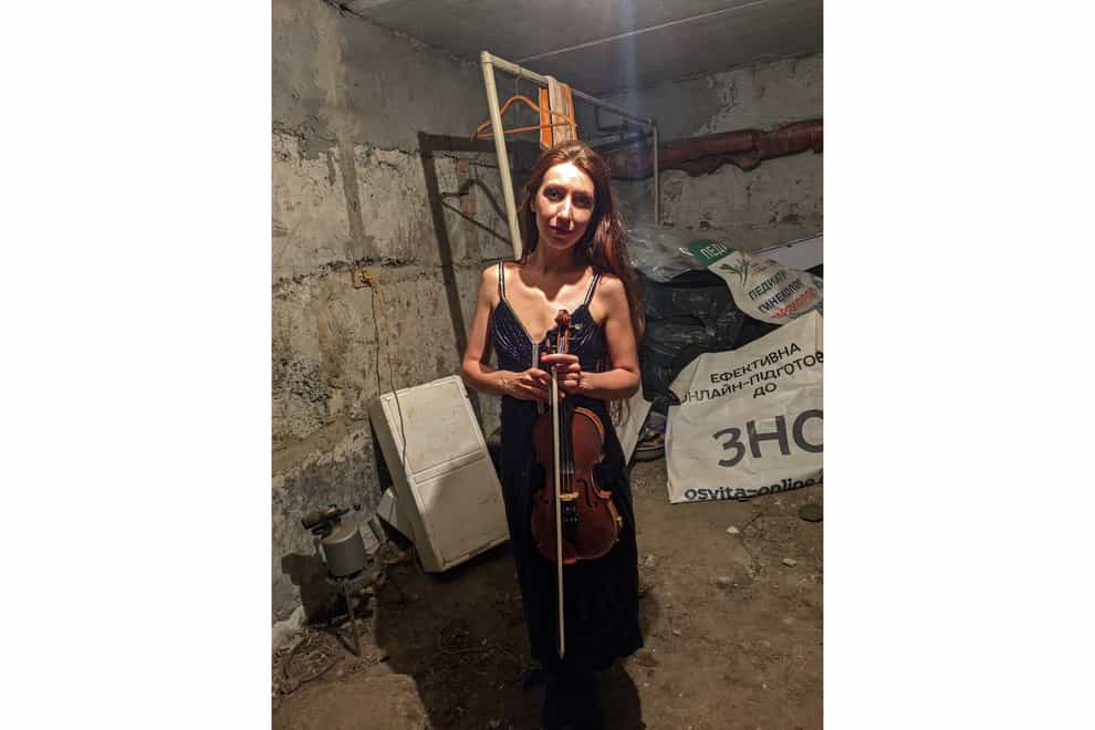Violinist Vera Lytovchenko in a cellar with her violin in Kharkiv, Ukraine (Vera Lytovchenko via AP)