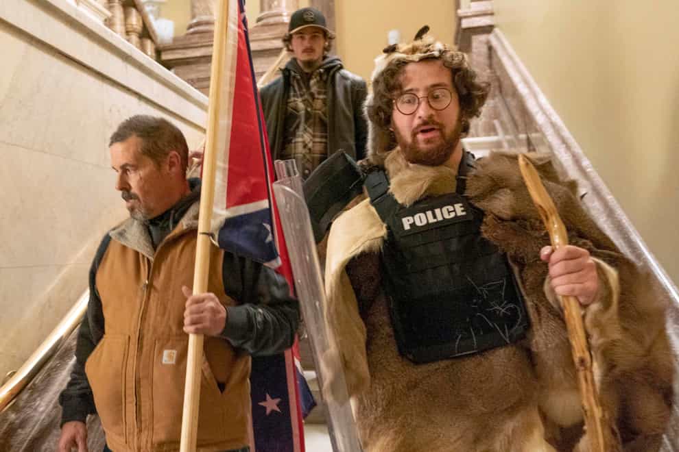 Supporters of President Donald Trump, including Aaron Mostofsky, right, who is identified in his arrest warrant, walk down the stairs outside the Senate Chamber in the US Capitol in Washington on January 6 2021 (Manuel Balce Ceneta/AP)