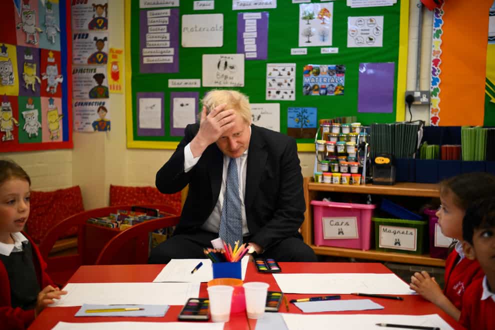 Boris Johnson prepares to paint with children during a visit at the Field End Infant school, in South Ruislip (Daniel Leal/PA)
