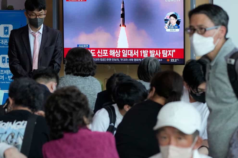 People watch a TV showing a file image of North Korea’s missile launch during a news program at the Seoul Railway Station (AP)