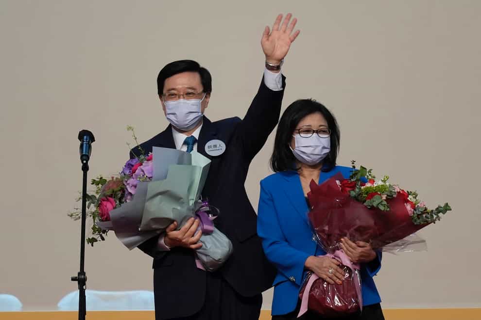 John Lee celebrates with his wife after declaring his victory in the chief executive election of Hong Kong (Kin Cheung/AP)