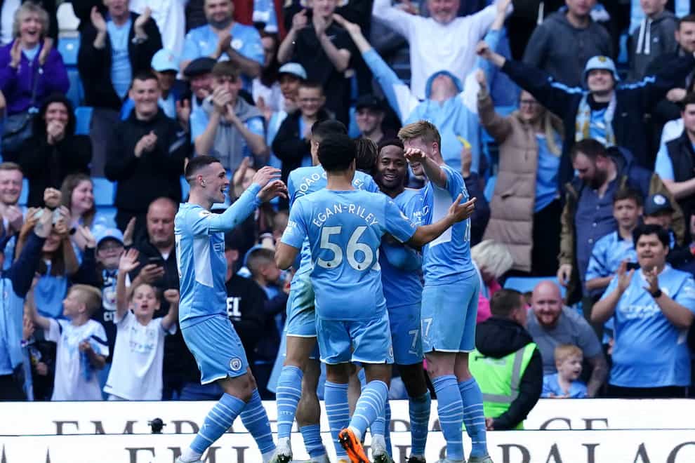 Raheem Sterling, second right, celebrates with his team-mates after scoring Manchester City’s fifth goal against Newcastle (Martin Rickett/PA)