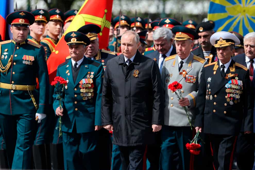 Russian President Vladimir Putin, centre, attends a wreath-laying ceremony at the Tomb of the Unknown Soldier after the military parade marking the 77th anniversary of the end of the Second World War, in Moscow, Russia, on Monday May 9 2022 (Anton Novoderezhkin/ Sputnik/Kremlin Pool Photo/AP)