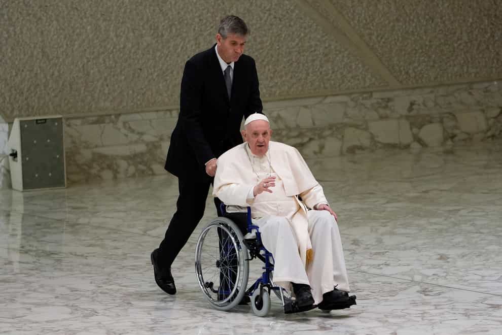 Pope Francis arrives in a wheelchair to attend an audience with nuns and religious superiors in the Paul VI Hall at The Vatican on Thursday May 5 2022 (Alessandra Tarantino/AP)
