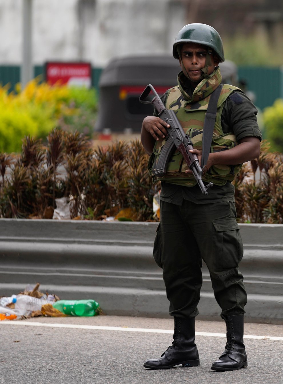 Sri Lankan troops stand guard outside the former prime minister’s residence a day after clashes between government supporters and anti-government protesters in Colombo (Eranga Jayawardena/AP)