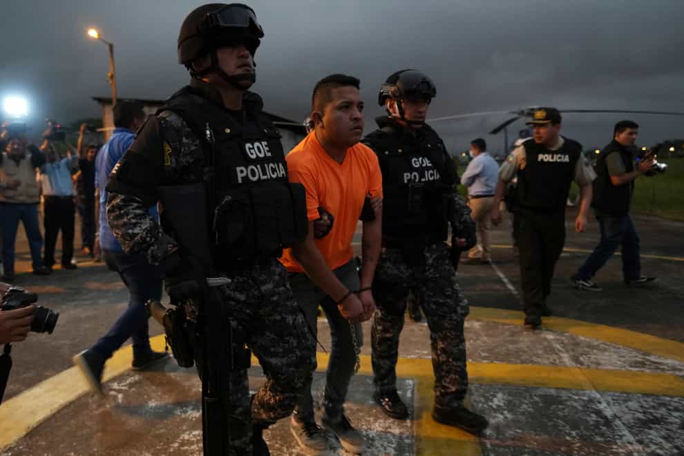 Gang leaders who are operating inside the Bellavista jail are transferred to other jails after a deadly riot broke out overnight in Santo Domingo de los Tsachilas, Ecuador, Monday, May 9, 2022. (AP Photo/Dolores Ochoa)