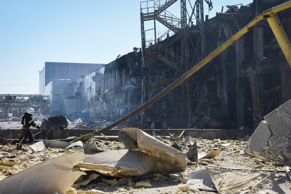 An Ukrainian firefighter works near a destroyed building on the outskirts of Odesa, Ukraine, Tuesday, May 10, 2022. The Ukrainian military said Russian forces fired seven missiles a day earlier from the air at the crucial Black Sea port of Odesa, hitting a shopping center and a warehouse. (AP Photo/Max Pshybyshevsky)