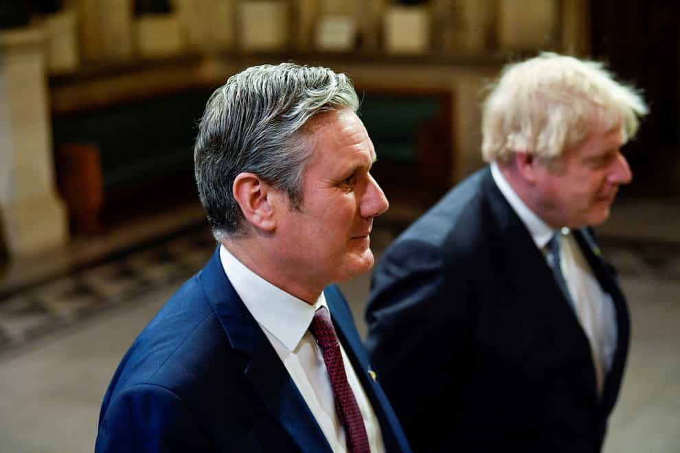 Leader of the Labour Party Sir Keir Starmer and Prime Minister Boris Johnson walk through the Members’ Lobby at the Palace of Westminster ahead of the State Opening of Parliament in the House of Lords (Toby Melville/PA)