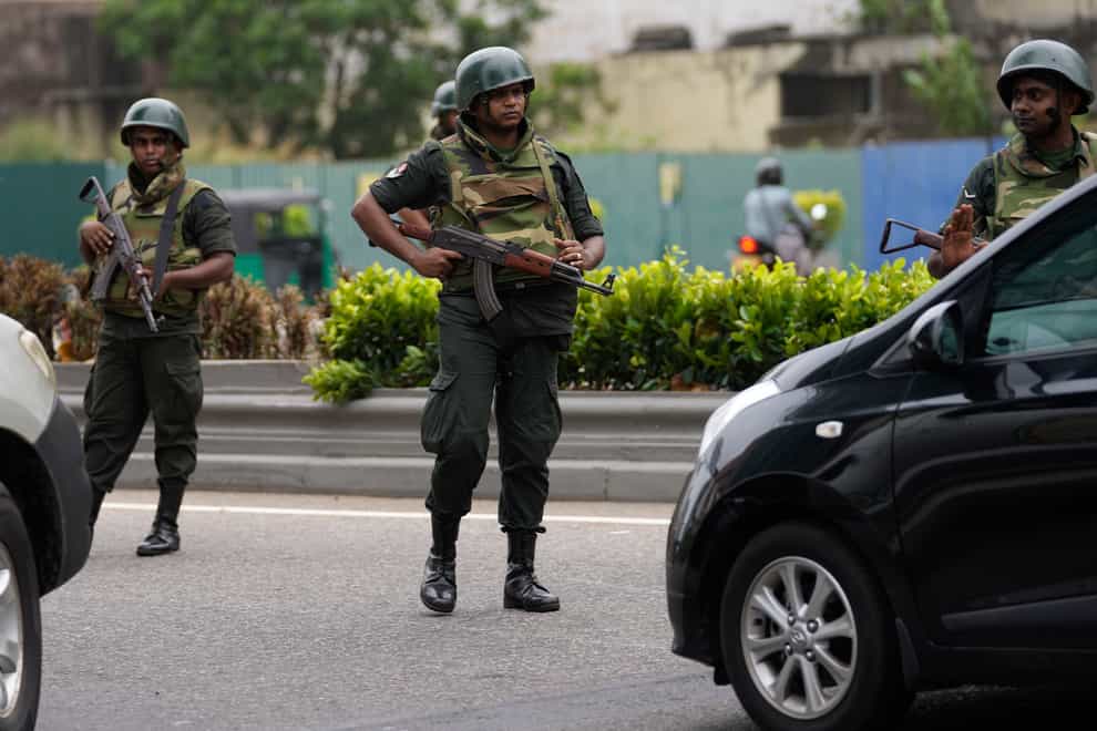 Soldiers man a checkpoint outside the prime minister’s residence in Colombo, Sri Lanka (Eranga Jayawardena/AP)