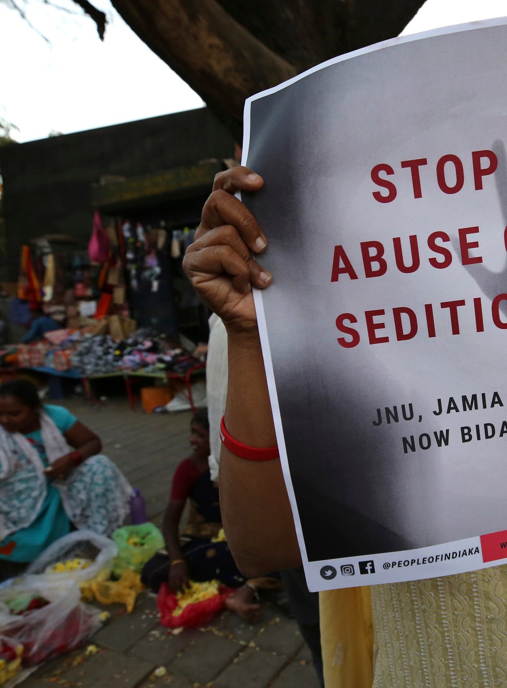 A woman holds a placard protesting against a sedition case in Bangalore, India, in 2020 (Aijaz Rahi/AP)