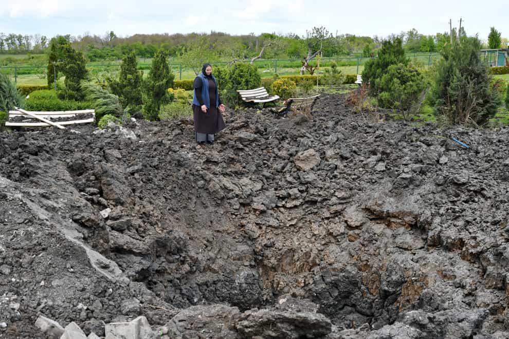 Orthodox Sister Evdokia gestures in front of the crater of an explosion, after Russian shelling next to the Orthodox Skete in honour of St John of Shanghai in Adamivka, near Slovyansk, in the Donetsk region, Ukraine (Andriy Andriyenko/AP)
