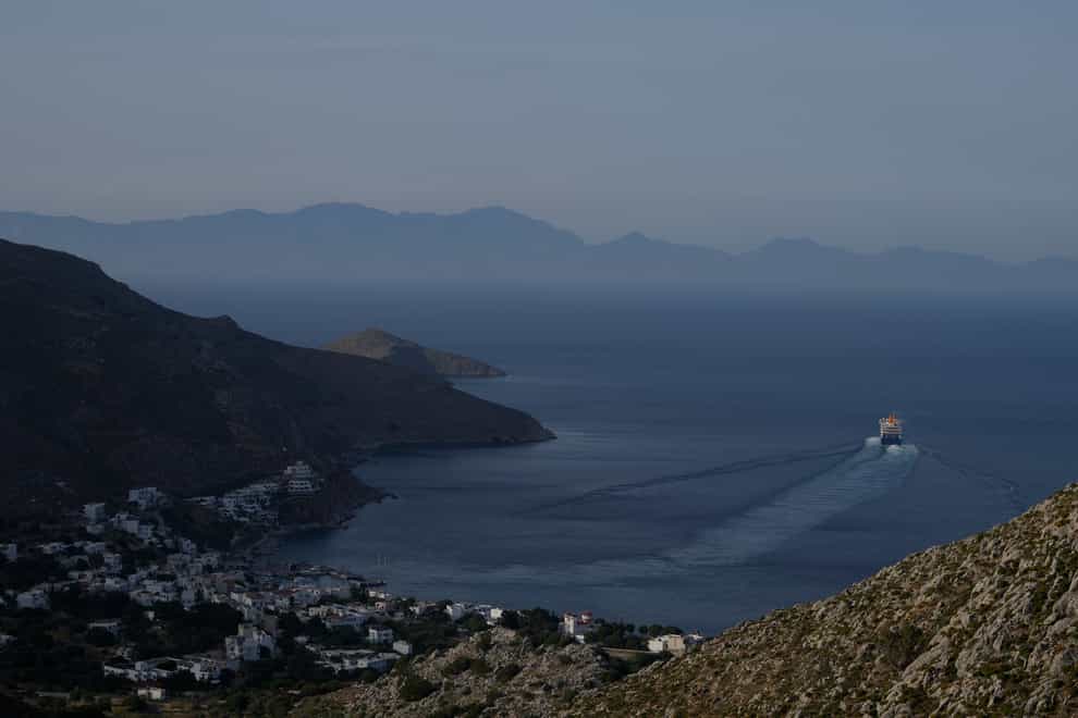 A ferry departs from Livadia port on the Aegean Sea island of Tilos, south-eastern Greece (Thanassis Stavrakis/AP)