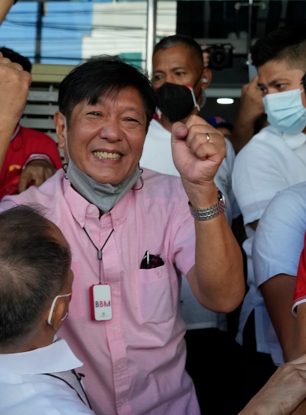 Ferdinand Marcos Jr celebrates as he greets the crowd outside his headquarters in Mandaluyong (AP)