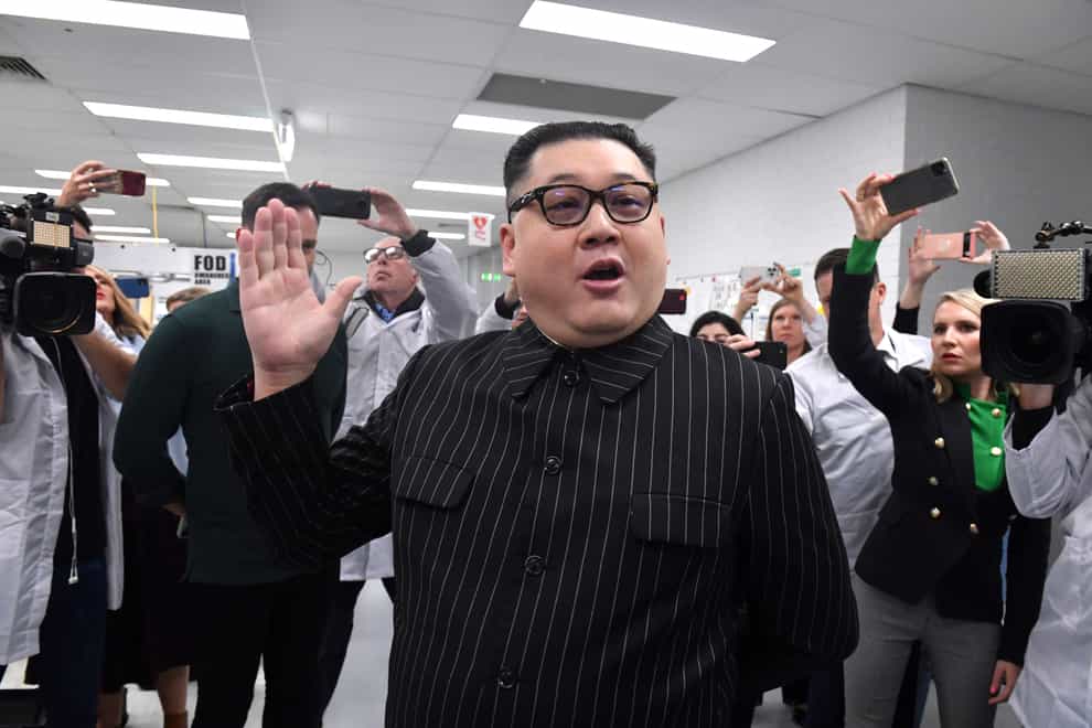 A man impersonating North Korea’s leader Kim Jong-un arrives as Prime Minister Scott Morrison leaves Extel Technologies manufacturing facility (AAP Image via AP)