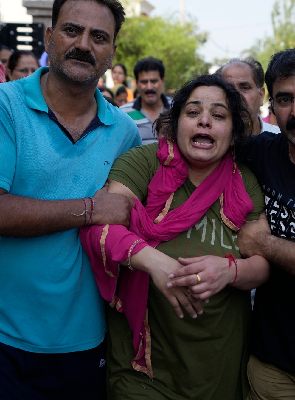 Meenakshi mourns during the cremation of her husaband Rahul Bhat, a government employee killed on Thursday, in Jammu, India (Channi Anand/AP)