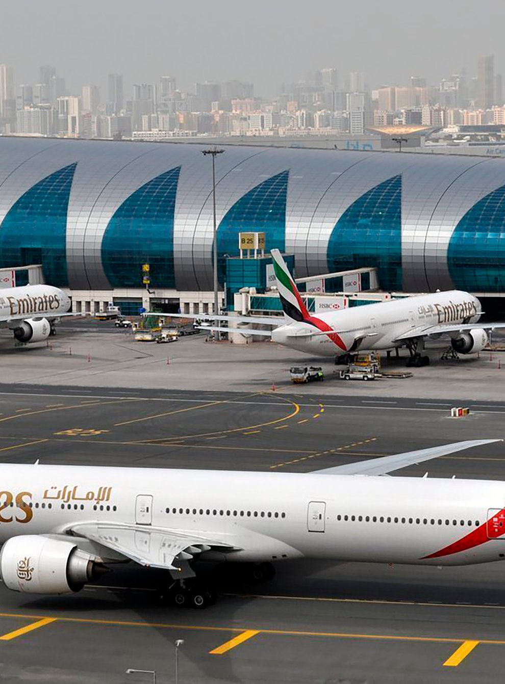 An Emirates plane taxis to a gate at Dubai International Airport (Adam Schreck/AP)