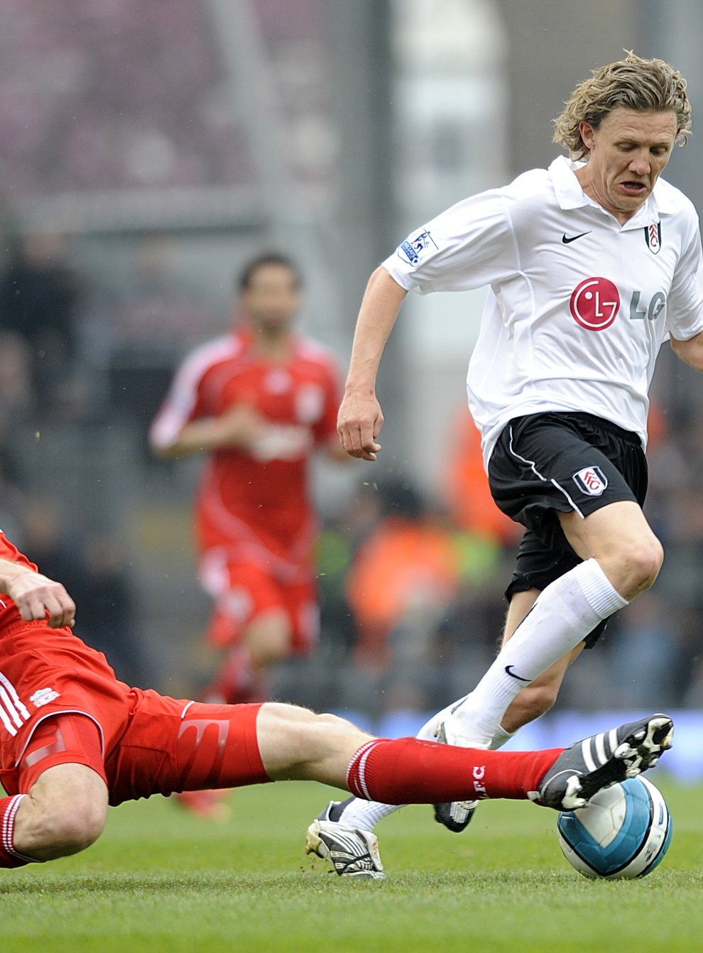 Fulham’s Jimmy Bullard (r) and Liverpool’s Sami Hyypia (l) battle for the ball (PA)